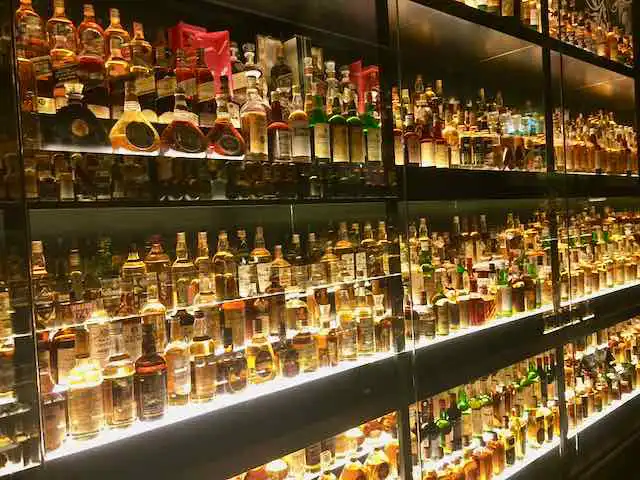 Yet more shelves lamp-packed with bottles of Scotch