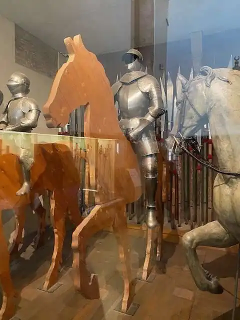Metal clad men playing on toy horses
