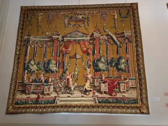 A musicians-and-dancers-themed tapestry at Musée des Tapisseries