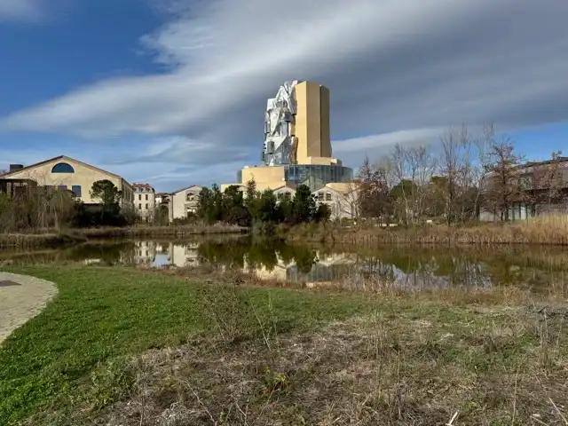 The pond in Parc des Ateliers, with the tower behind it