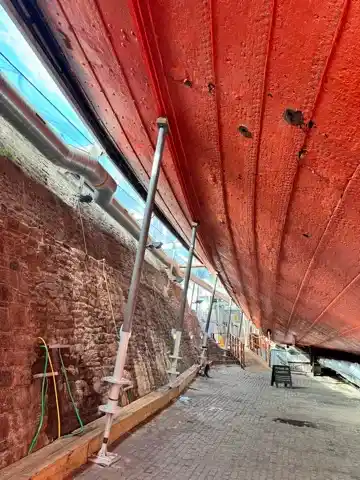 In the dry dock, under the hull