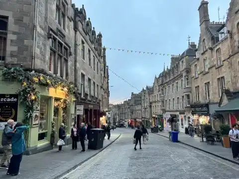Cobblestone street lined with old stone buildings.