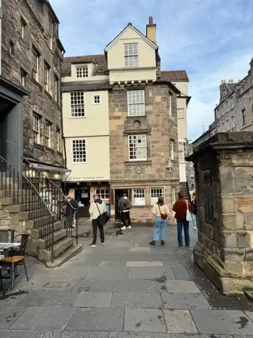 Picture of an old building constructed of stone blocks on the right side and smoother yellow surface on the left. It's the John Knox House.
