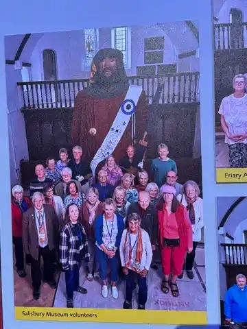 Picture of a picture of Salisbury Museum volunteers posing in front of the medieval giant
